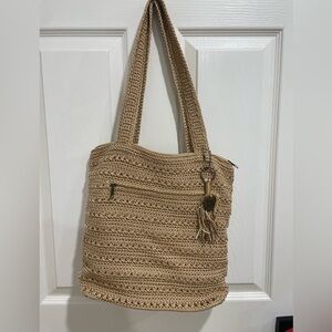 The Sak tan woven crochet shoulder bag zip pocket tassel detail